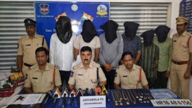 Jadcherla police officials during a press conference with arrested interstate theft gang members and recovered gold jewellery displayed as evidence.