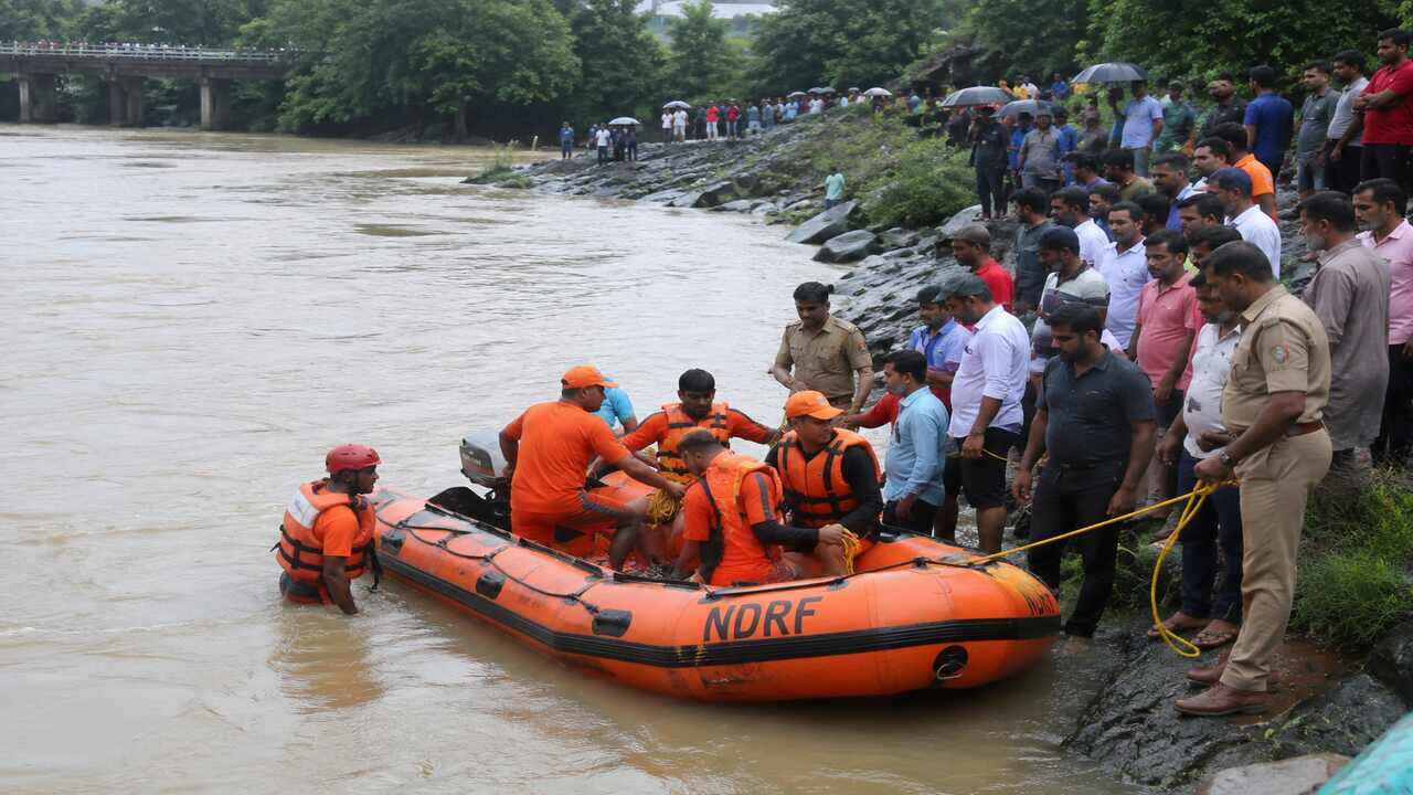 Rescue teams carrying out operations near a river in Karnataka after a tragic accident involving people swept away by rising water currents.