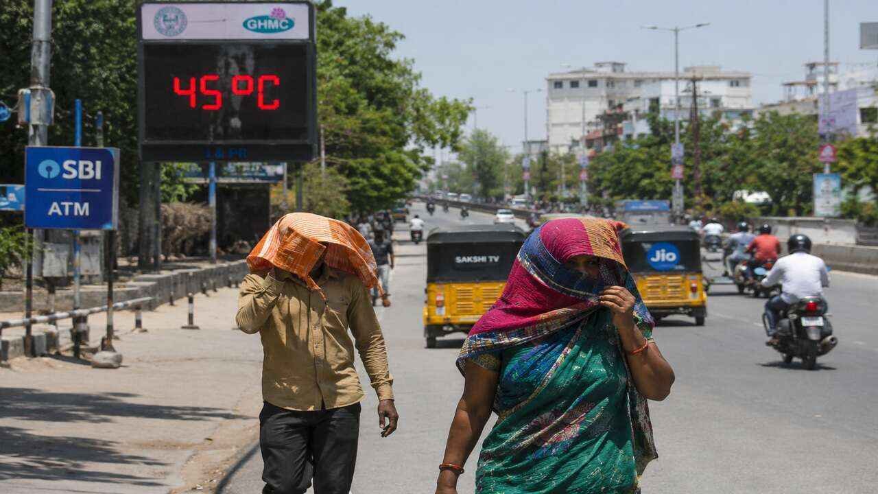 People walking under extreme summer heat in Telangana as temperatures cross 45 degrees during ongoing heatwave conditions