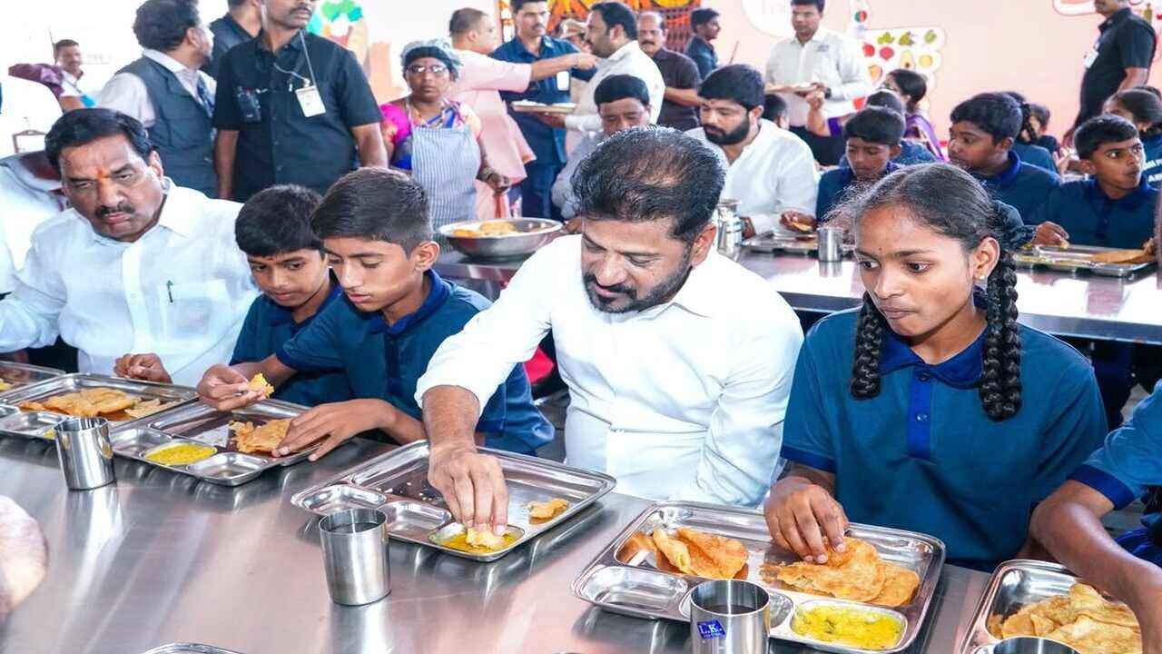 Revanth Opens TPS: Chief Minister Revanth Reddy interacts with students during the inauguration of Telangana Public School in Arutla and shares breakfast with them.