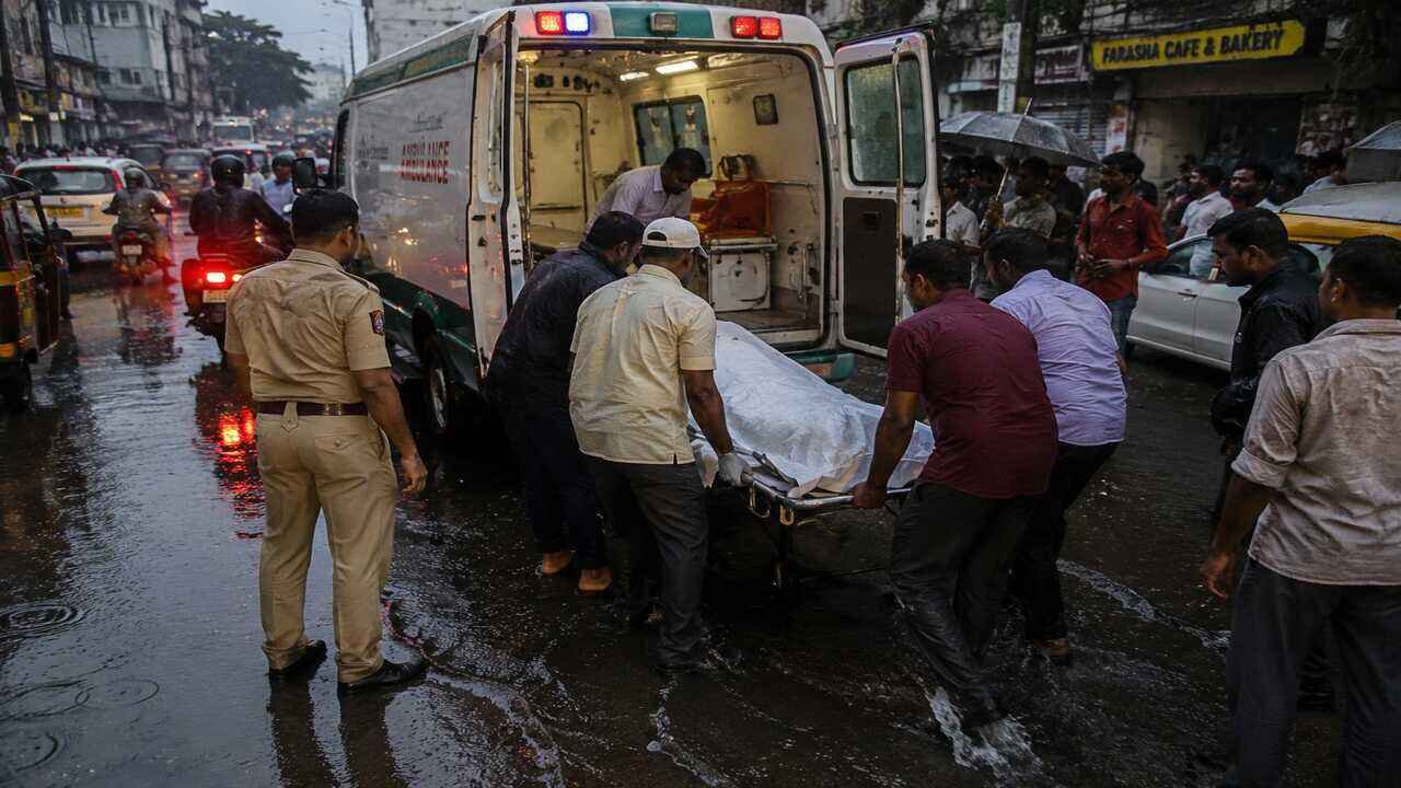 Emergency personnel and local residents respond after a fatal electrocution incident during heavy rainfall in Hyderabad, highlighting safety concerns in waterlogged areas.